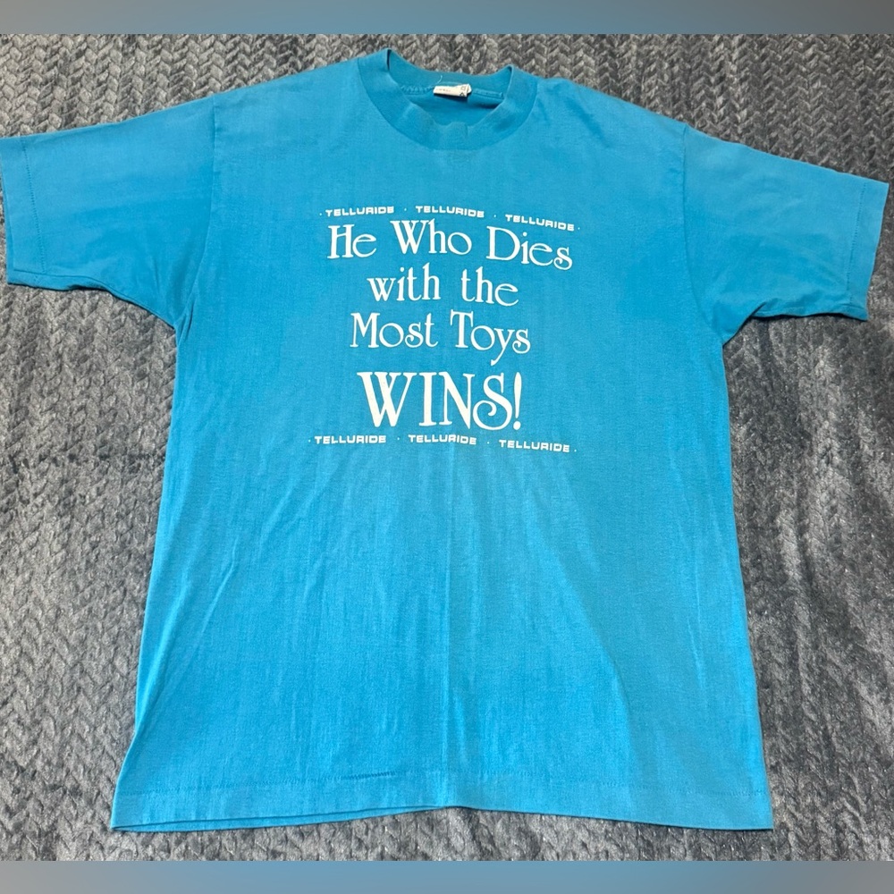 Vtg 80s Hef-T Blue T Shirt He Who Dies With The Most Toys Wins Sz L Telluride CO